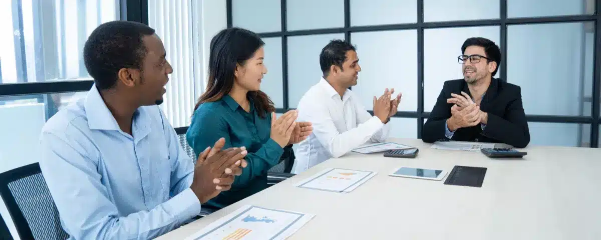 Séance de feedback positif et reconnaissance au travail au sein d'une équipe projet diversifiée.