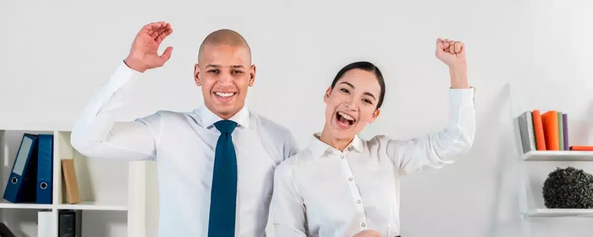 Deux collaborateurs heureux, ayant confiance en eux-mêmes dans un bureau.